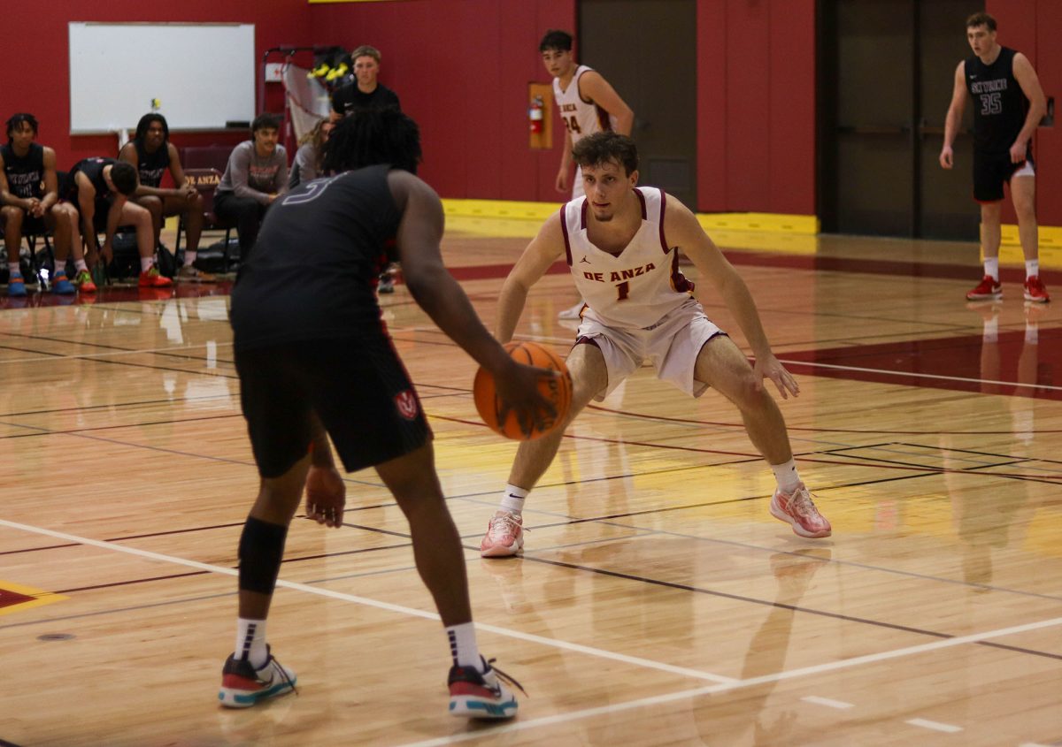 Guard Cayden Tanger (De Anza No. 1), 19, business administration major, defends against a Skyline Trojan in the De Anza gymnasium on Jan. 31.