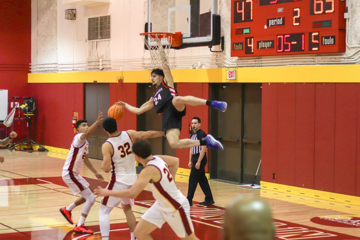 Antonio Pusateri (San Francisco No. 24), hangs from the hoop in front of De Anza players in the De Anza gymnasium on Jan. 22.