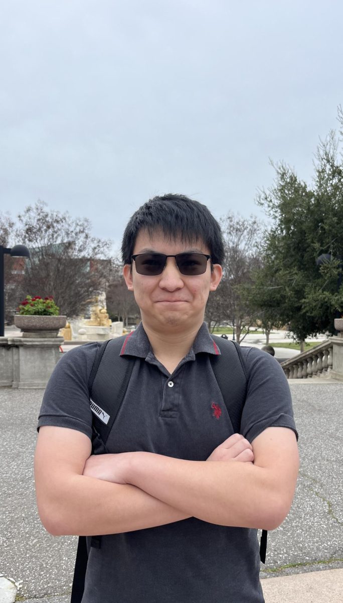 Charles Chang, 19, film major, stands near the Sunken Garden.