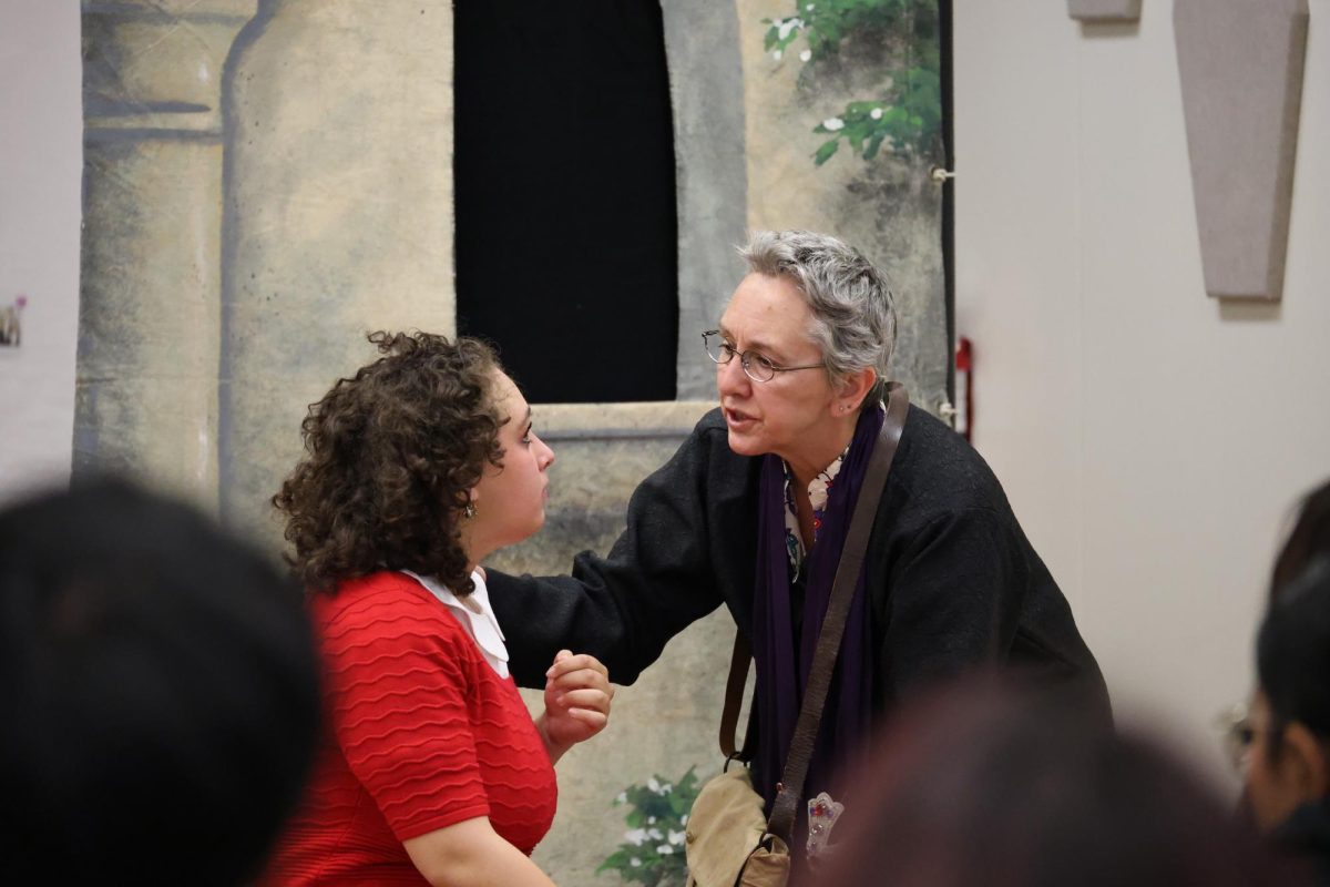 Juliet, Sylvia Abrams-Wolfson, wakes up from being in a state of apparent death and hears Romeo has died by Friar Laurence, Valerie Fachman, in the "Romeo & Juliet in the 1960s."