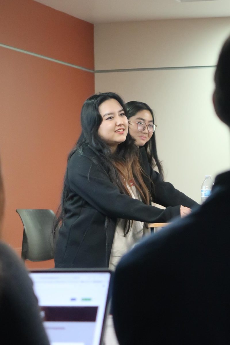 DASG Vice President Aura Ozturk, 19, computer science major, and Elections Commissioner Wadi Lin Lei, 21, computer science major, take the podium to propose changing the title of vice president to "Chair of Administration" during the Jan. 22 DASG General Senate meeting in the Student Council Chambers.