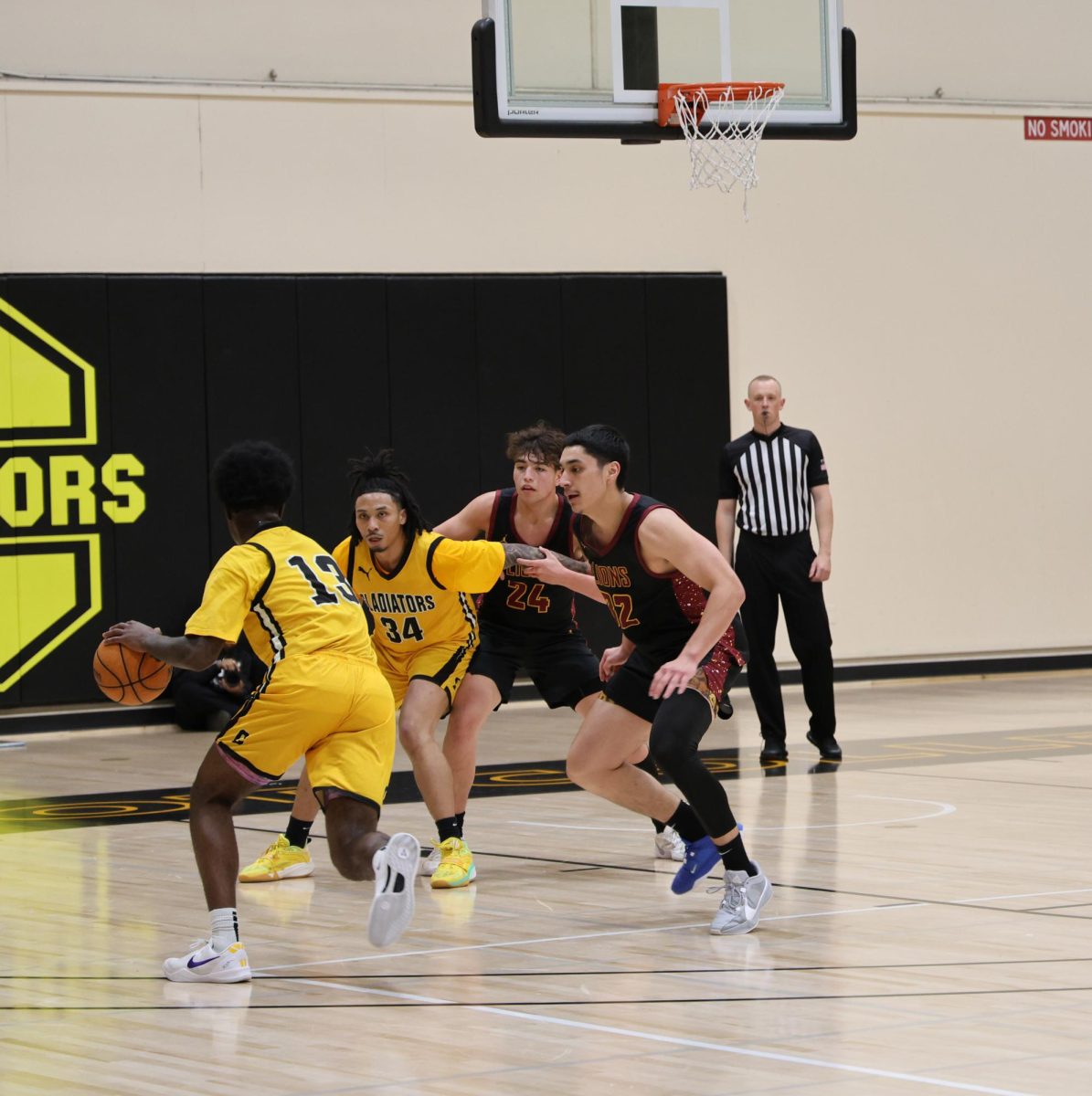 Forward Zion Yeargin (Chabot No. 13) dribbles the ball while De Anza players try to stop him on Feb. 6 at the Chabot College main gymnasium.