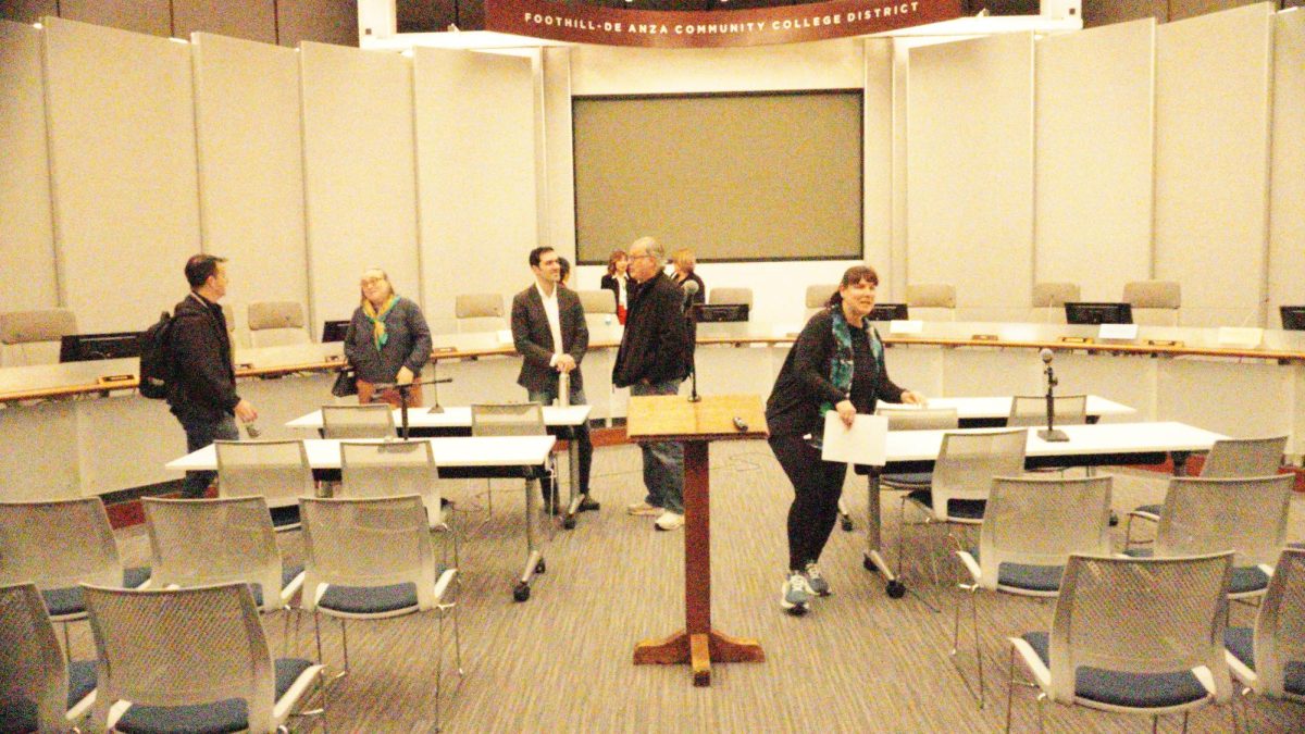 Alexander Gvatua talks to guests and Laura Casas reorganizes desks after the Board of Trustees meeting on Feb. 3. 