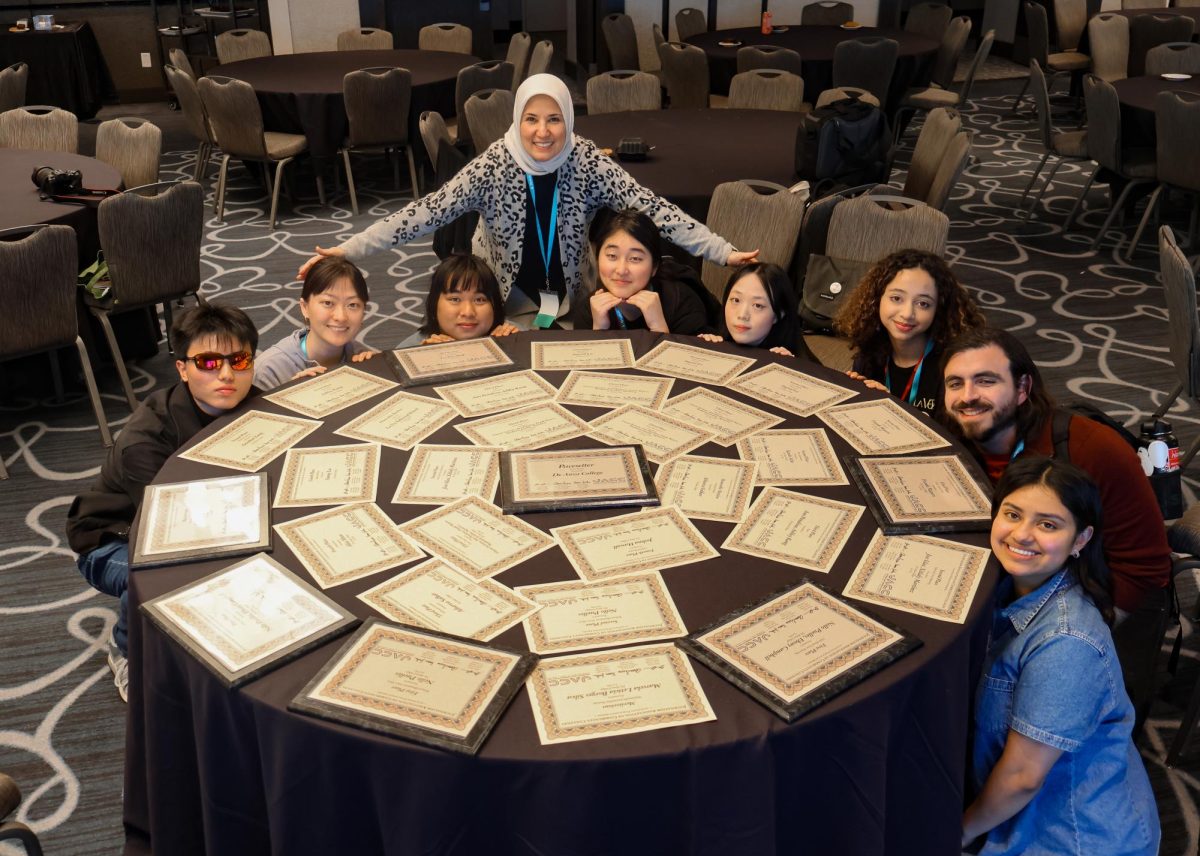 La Voz students pose with their awards from the Journalism Association of Community Colleges spread out on a table in the Associated Collegiate Press Spring College Media Conference in Long Beach on March 8.