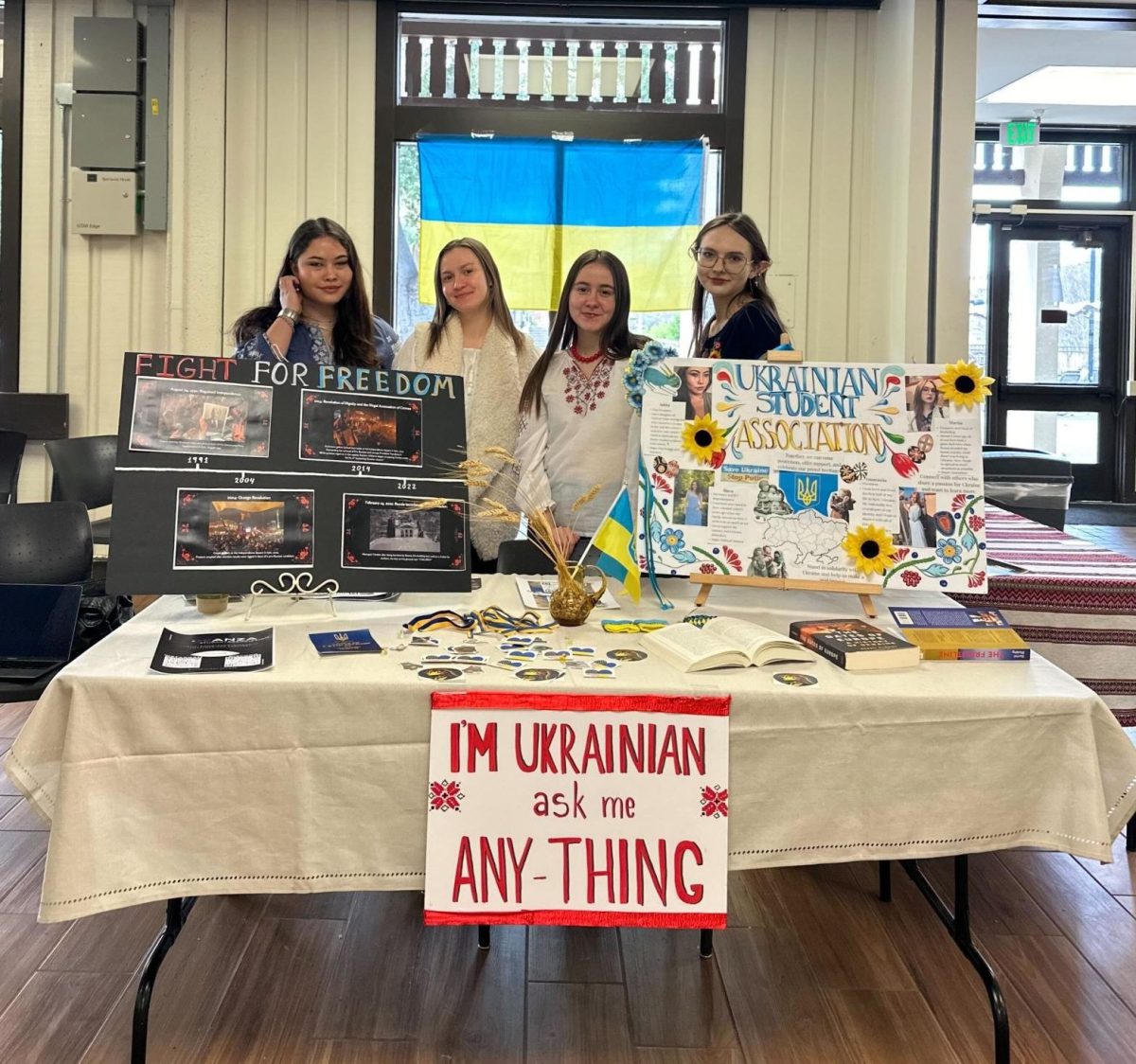 From left, Anastasiia Holovchenko, 19, psychology and data science major and vice president of the Ukrainian Students Association, Anastasiia Klymenko, 20, economics major, Yaroslava Klymenko, 18, political science major and ICC representative and Mariia Protasova, 20, animation major host an "ask me anything" table at the Hinson Campus Center on Feb. 24.