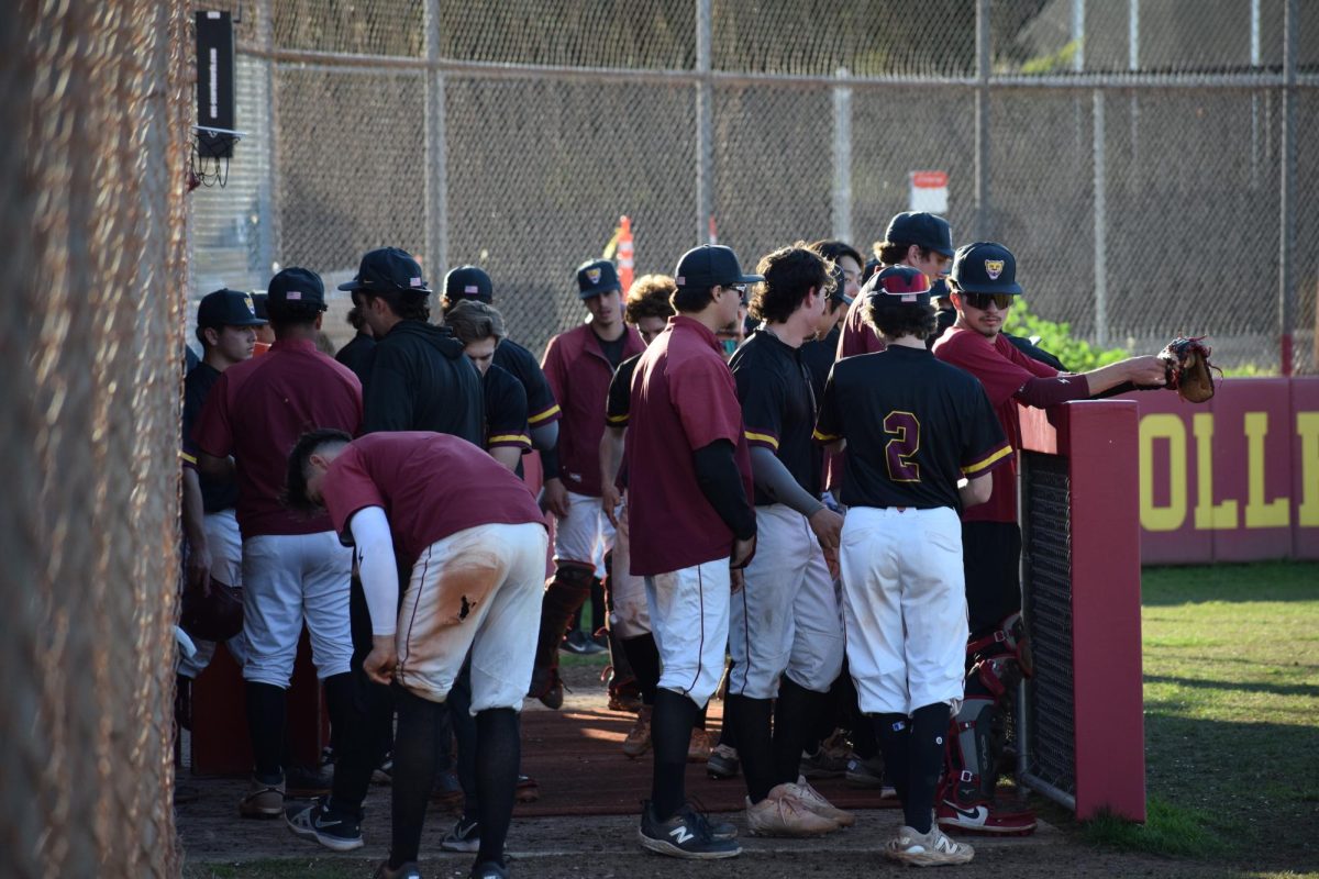 The men's baseball team gathers in the dugout at the De Anza baseball field on Feb. 20.