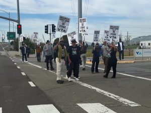 VTA workers continuously walk down Zanker Road, focusing drivers' attention with signs on March 10.