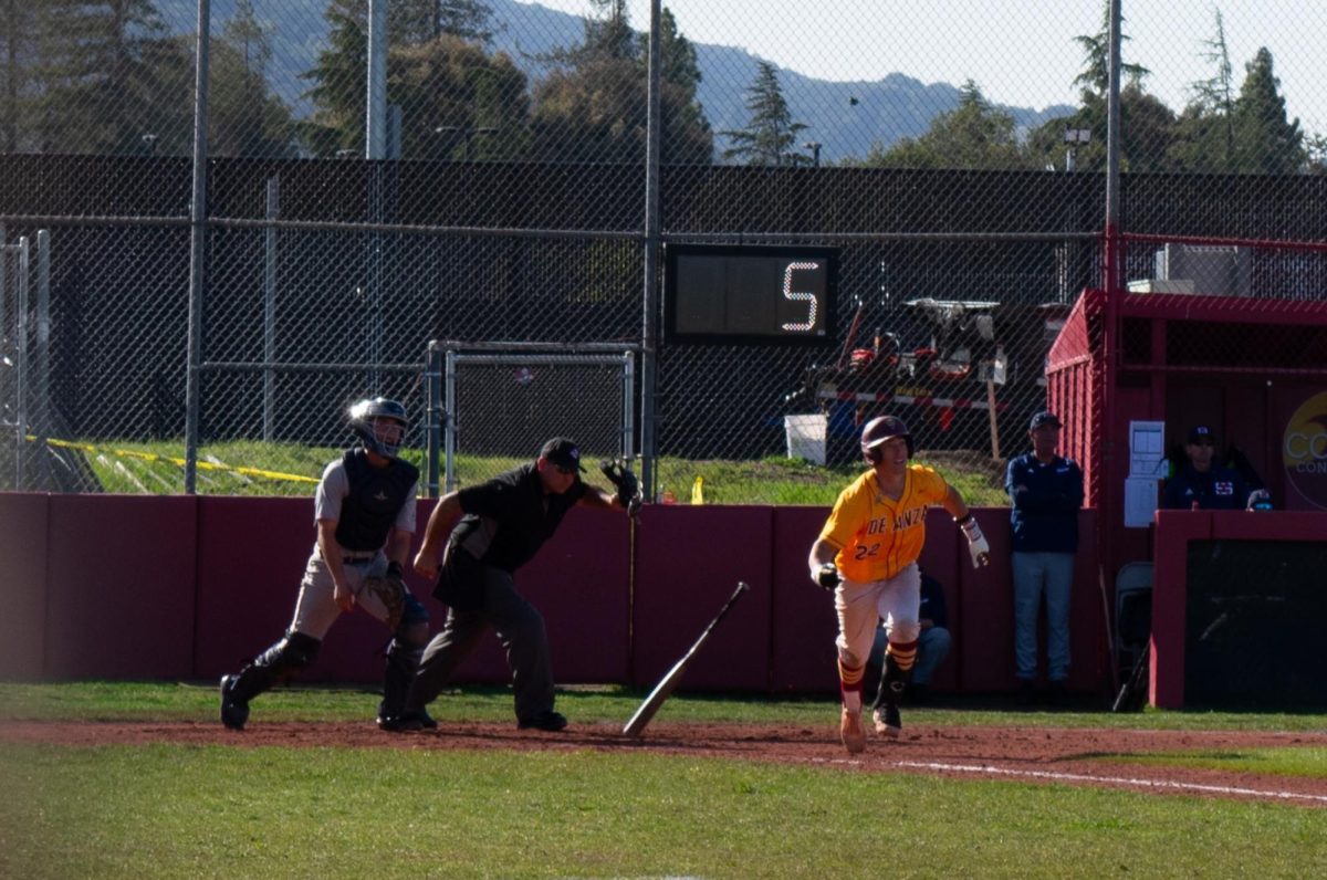 Infielder Mateo Rodriguez (De Anza No. 22) runs to first base after hitting ball at De Anza baseball field on March 18.