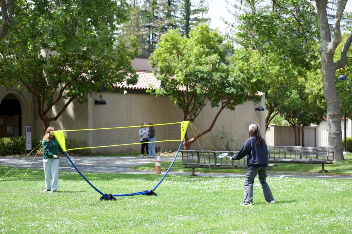 From left, Mahia Rodriguez, 18, plays Amy Huynh, 17, business major, in a quick game of badminton at De Anza's open house on April 26. De Anza provided a variety of games and activities for families and friends to bond over.