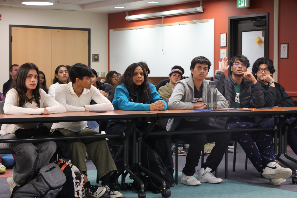 (From left to Right) Arhaam Azhari, 20, computer science major and Kavi Kumaresan, 20, film and television major speak in support of Elevate candidates to a DASG Sentaor Election Certification and Complaints meeting on April 16.