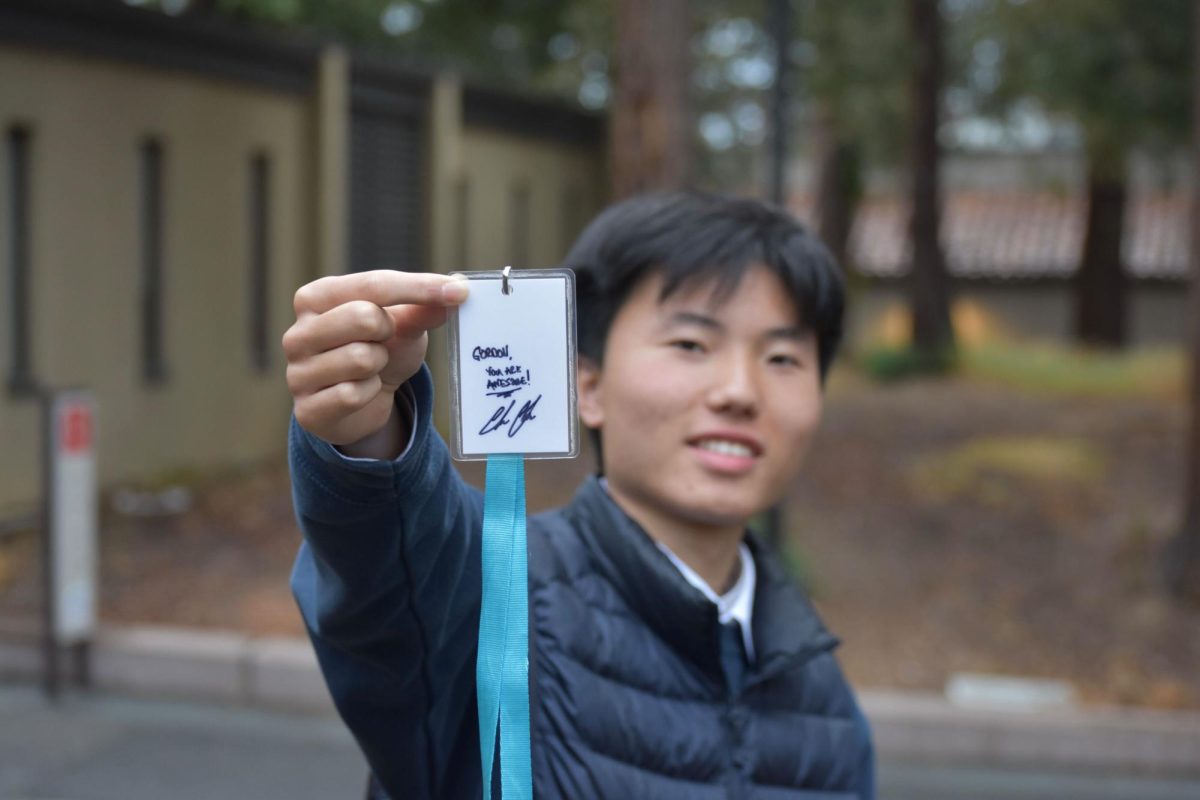 Gordon Yang, a dual enrollment student, holds up his press pass that Graham autographed on Friday, April 25.
