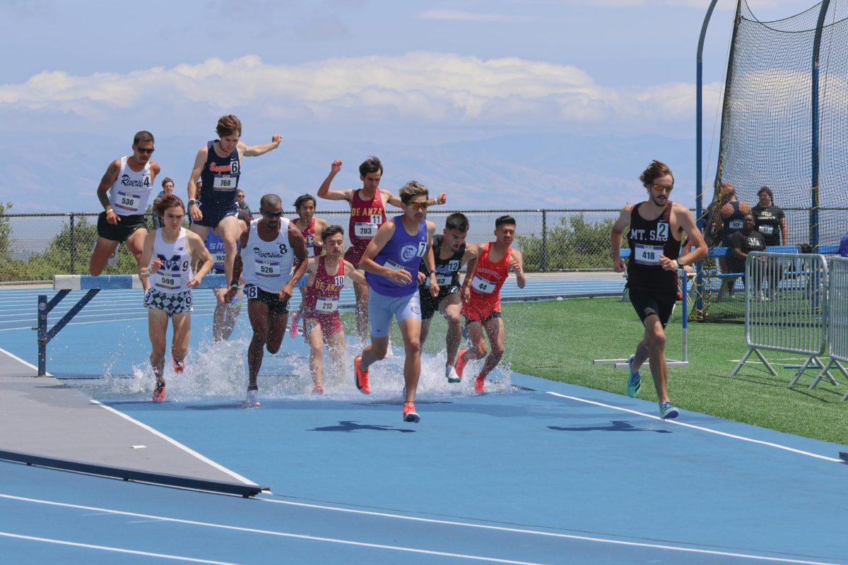 Men's 3,000-meter steeplechase competitors jump over the barrier during the 3C2A Track and Field State championship at the College of San Mateo on May 17.