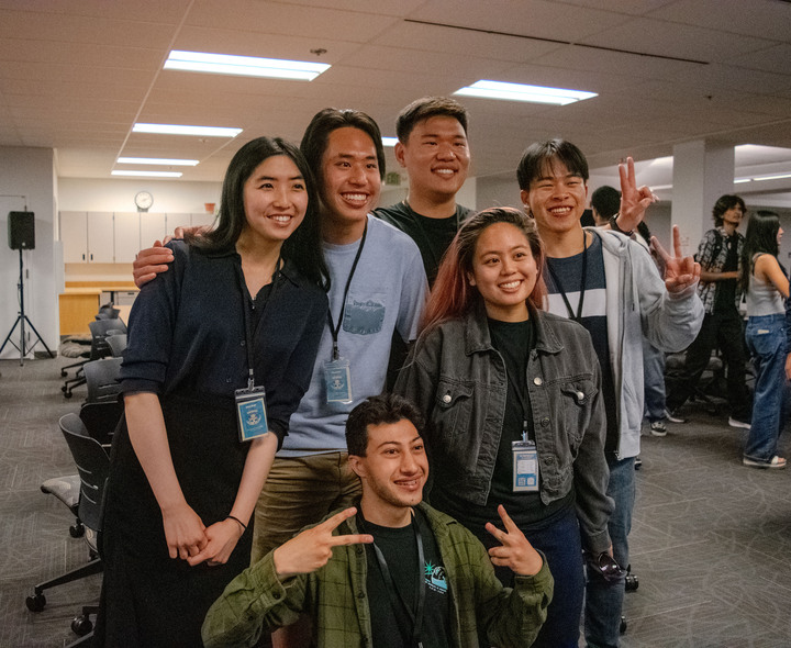 From left, Julia Wei, 25, computer science major, Aaron Ma, 16, computer science major, Hamza Zafer, 21, cognitive science major, Jacob Kao, 26, data science major, Min Gacayan, 26, computer science major, and Osbert Huang, 21, computer science major pose in the Advance Techonology Center on May 30 after winning first place for creating the "Rich Life Planner." The team worked together for the first time to create an app that estimates how quickly a student can earn their money back from college tuition.