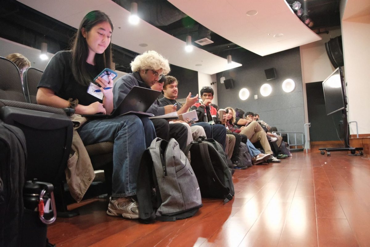 La Voz staff prepare to take notes and write questions for the keynote speakers.