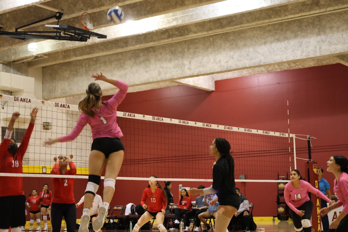 Ayla Cakisic (De Anza No. 1), 19, biology major, jumps to make a hit as De Anza teammates prepare to defend on Oct. 1.