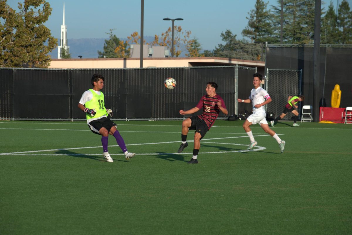 Forward Eric Serrano (De Anza No.22) prepares to trap the ball in front of Monterey Peninsula's backup goalie, and defender Pimental Guy (MPC No.3) at De Anza on Oct. 21.