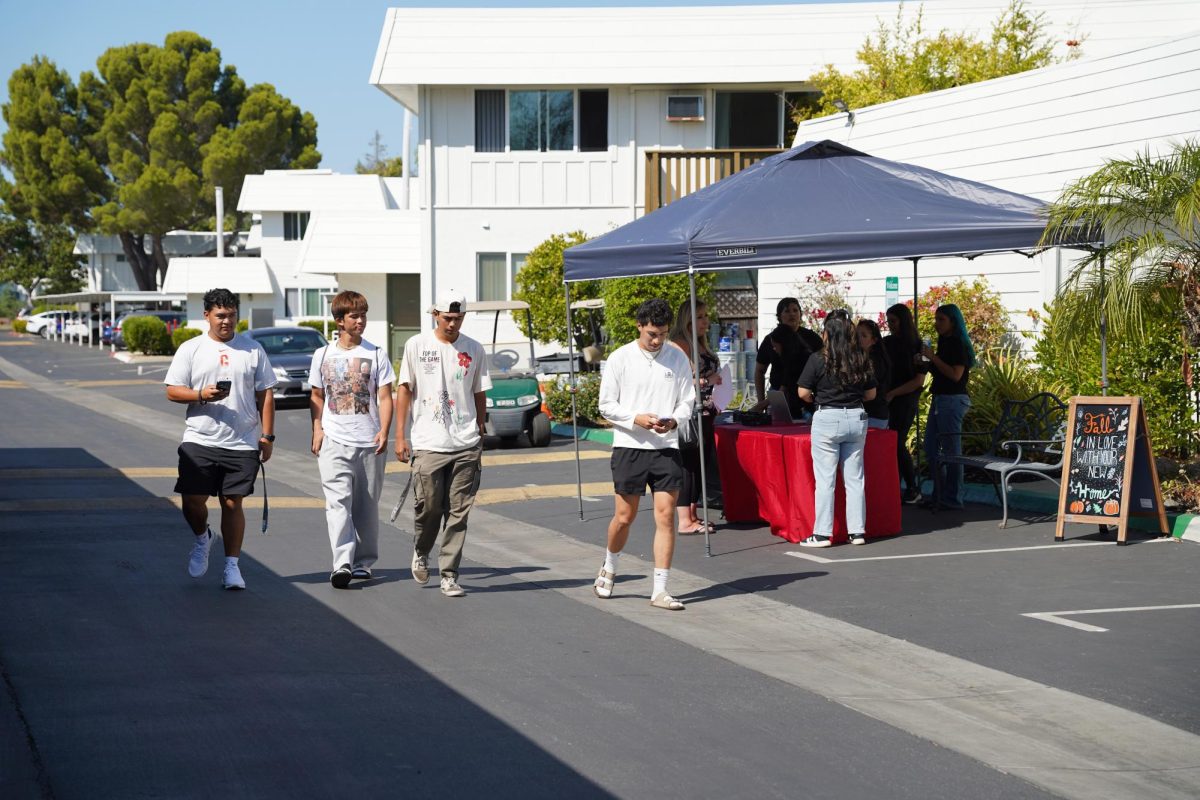 Staff members guide new residents through the move-in process, and students walk to their apartments on the first official day of student move-in, Sept. 19.