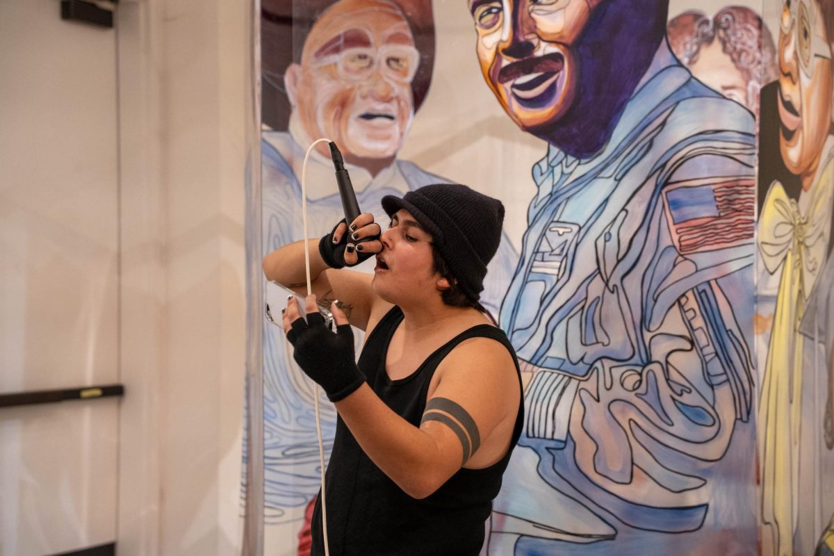 Jamie Chapparosa, 22, music major, performs “How Deep Is Your Love” by the Bee Gees during the First Thursday event at the Euphrat Museum of Art on Dec. 4.