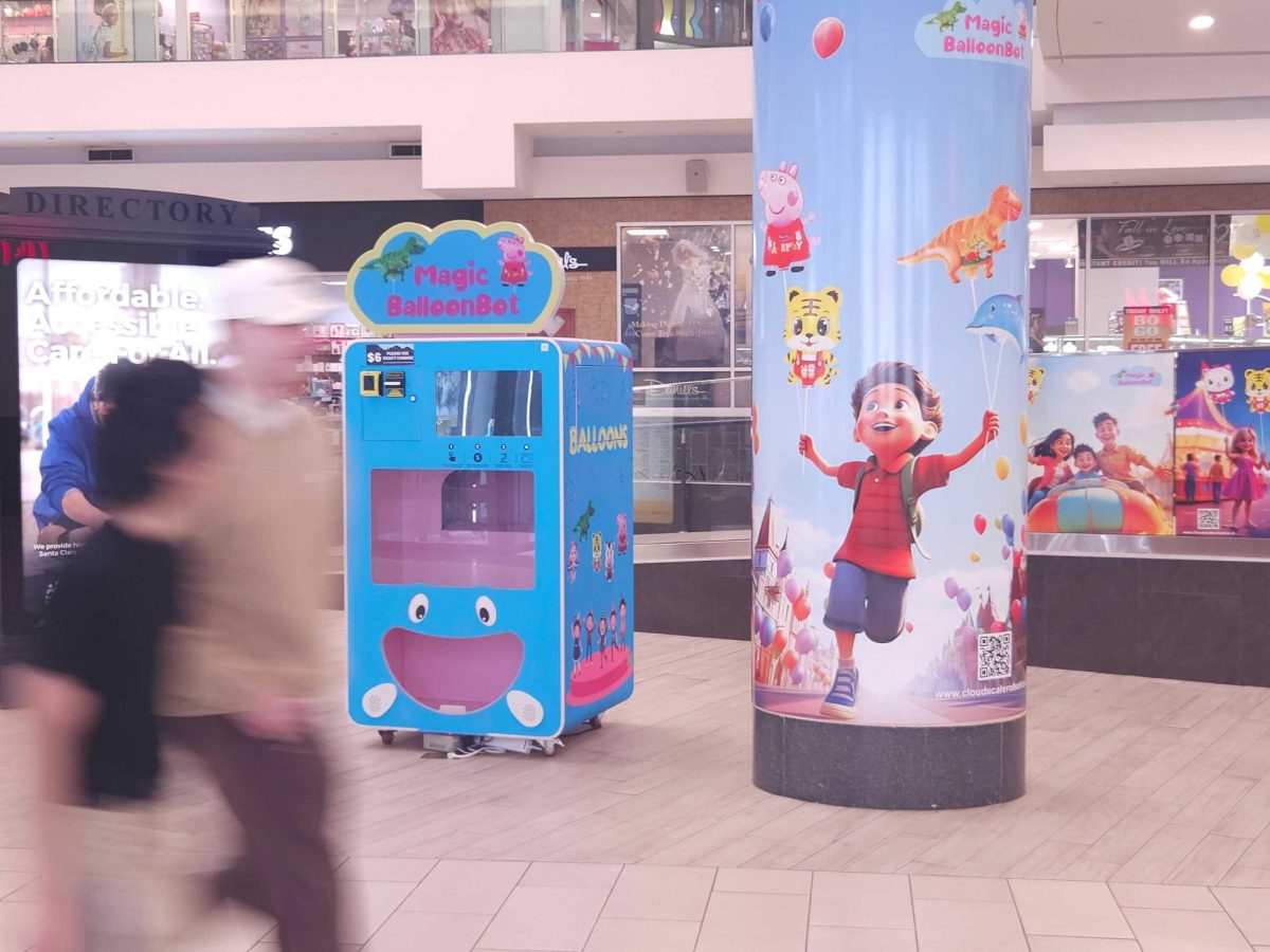 A group of friends walking past AI advertisements at Eastridge Mall on Jan. 20.