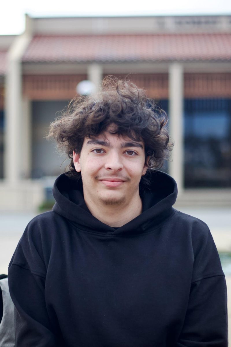 Tomer Friedman, 19, kinesthesiology major, sits by the fountain in the main quad.