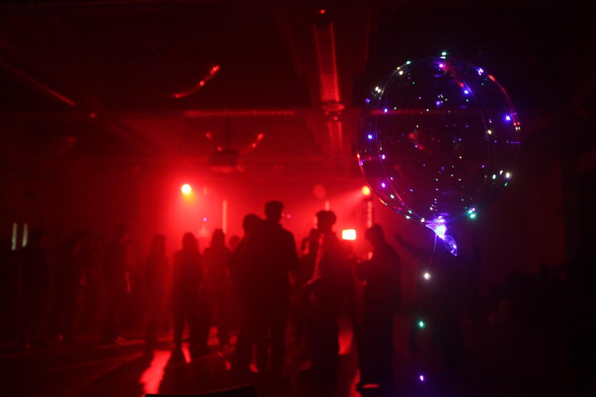 Students stay on the floor as the DJ set continues into the night in Conference Rooms A and B on Feb. 20.
