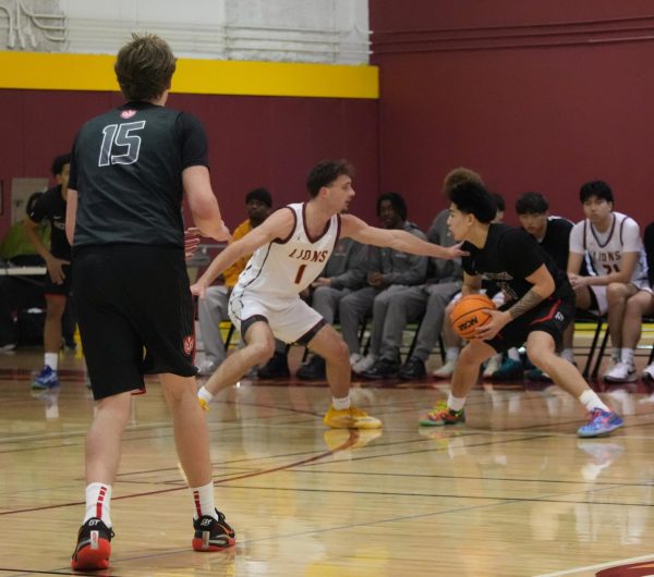 Guard Cayden Tanger (De Anza No. 1), 19, business administration major, defends against Trojan point guard Branden Antiporda (Skyline No. 11) from passing the ball in the De Anza College Main Gym on Feb. 20.