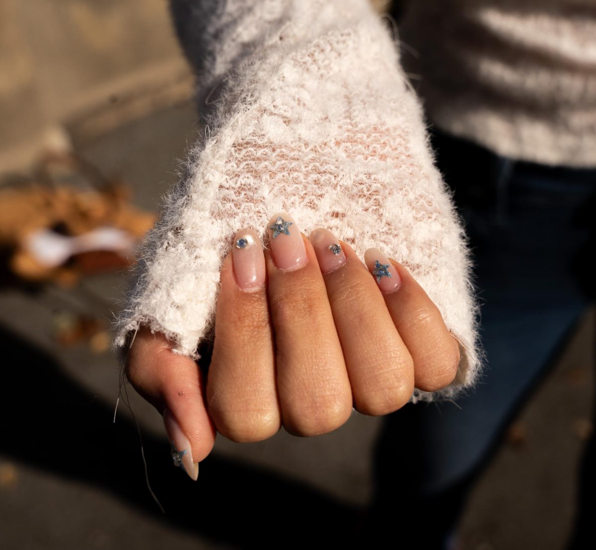 Rere Wu, 18, economics major, shows off blue sequin nail art she collaborated on with a friend.