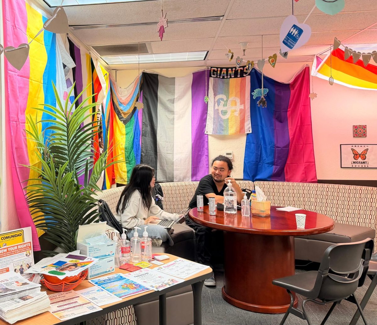 The Pride Center’s reception area doubles as a cozy community corner, where students can relax, connect, and access LGBTQ resources surrounded by flags representing the spectrum of identities and experiences.