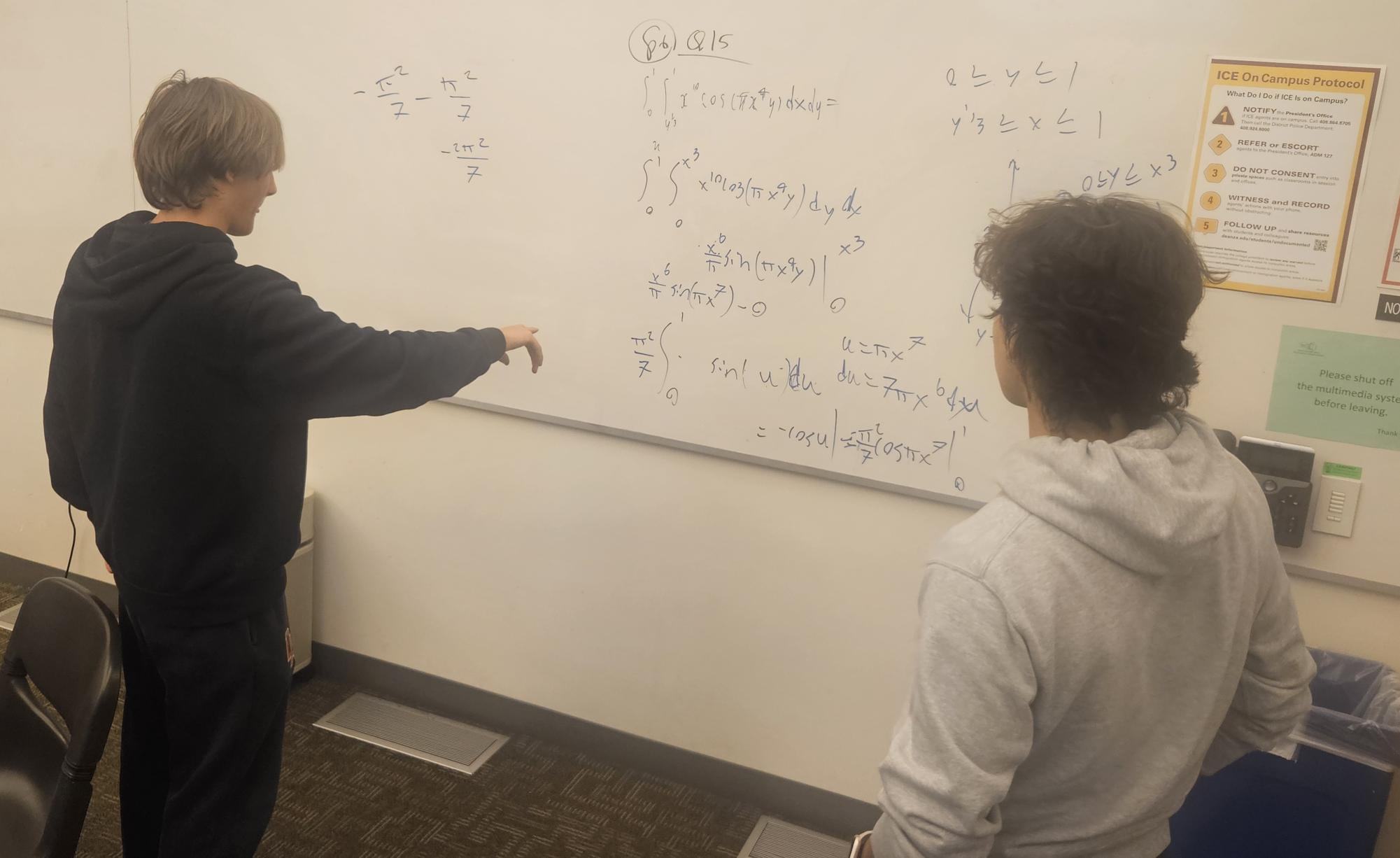 Milo Switzer, 18, mechanical engineering major (left) discusses equations and formulas with Artem Khorev, 20, computer science major (right) on Feb. 17.