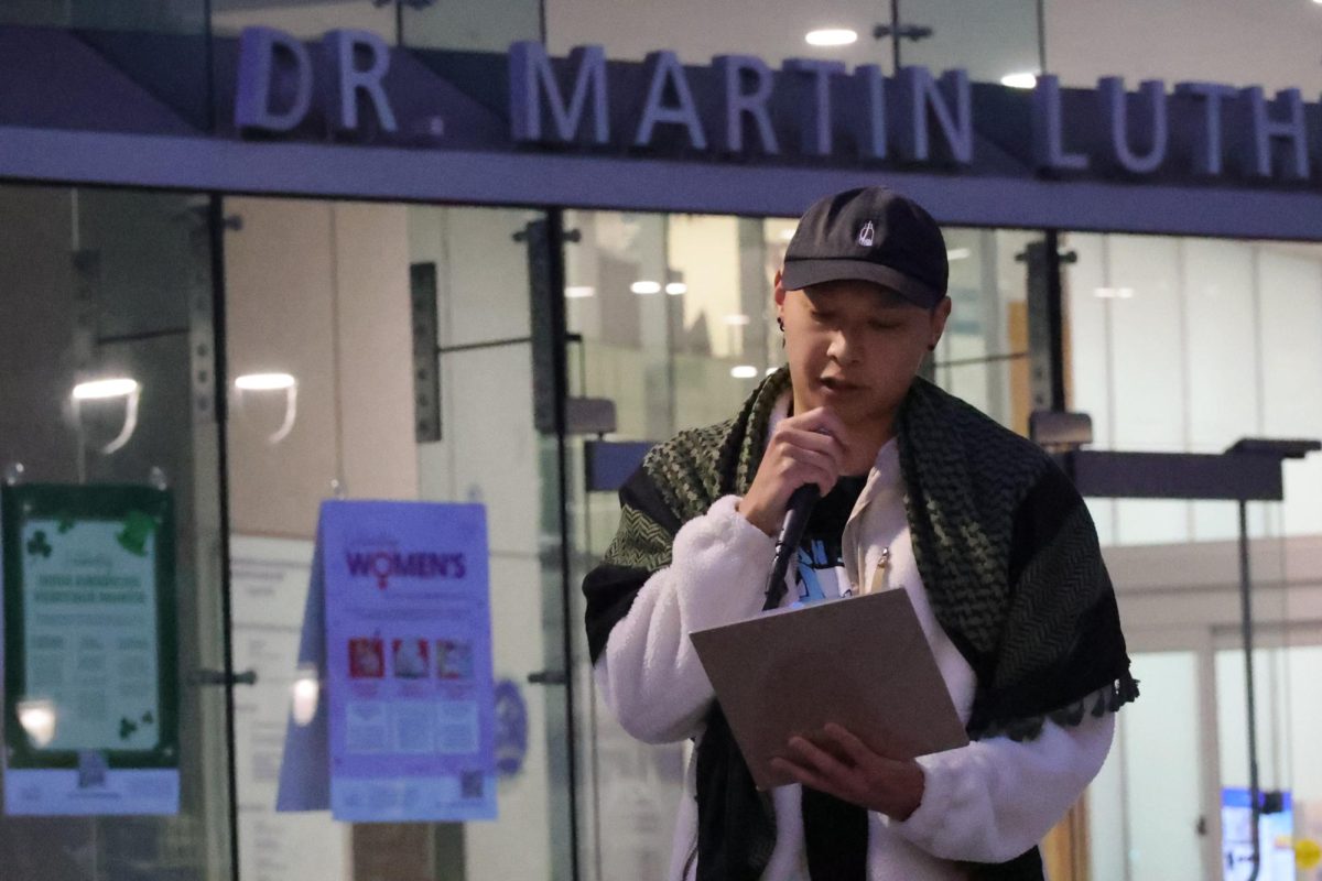 Phillip Nguyen, member of San Jose Against War, speaks to protesters in front of the Dr. Martin Luther King, Jr. Library in San Jose on March 3.