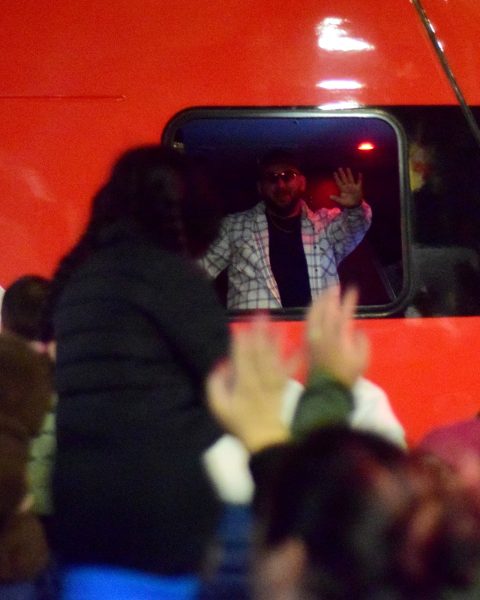 A Caltrain operator waves out to Dec. 7, 2024's holiday crowd, hyping up the crowd before the main attraction stops by. With the impending service cuts ahead, on top of hiking its fares, the agency has already implemented staff freezes as it stares down a potential wave of layoffs.