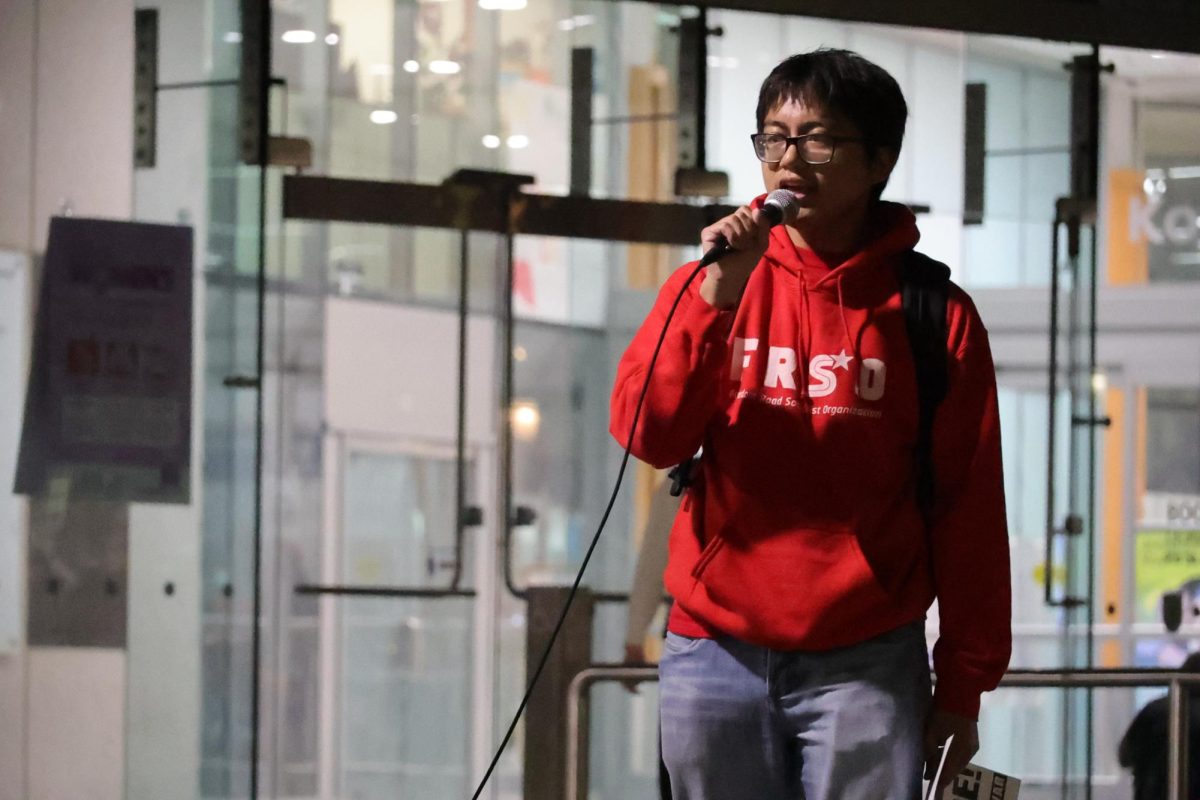 John Duroyan, SJSU Students for a Democratic Society president, leads the chants opposing the United States actions at Martin Luther King library on March 3.