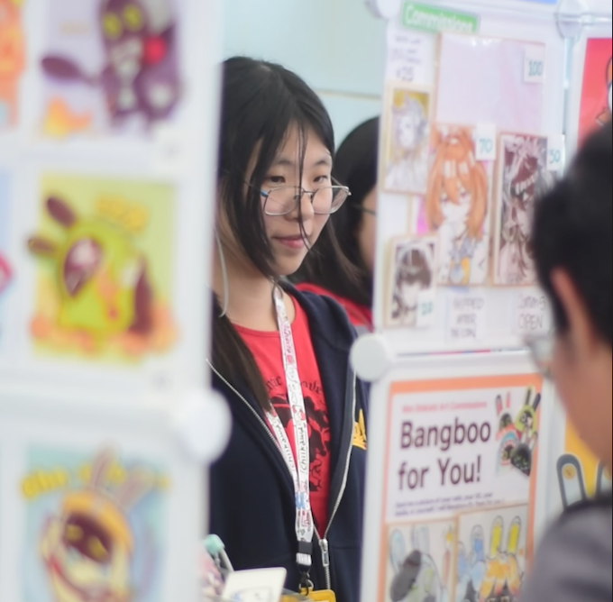 Sophie Ling talks with a customer at the Happy Horsie booth at BART Mart 2's "horse zone" at Millbrae Intermodal Station on March 26.