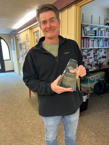 Robert Stockwell holds his "Advocate of the Year" award in the F2 building on Feb. 25.