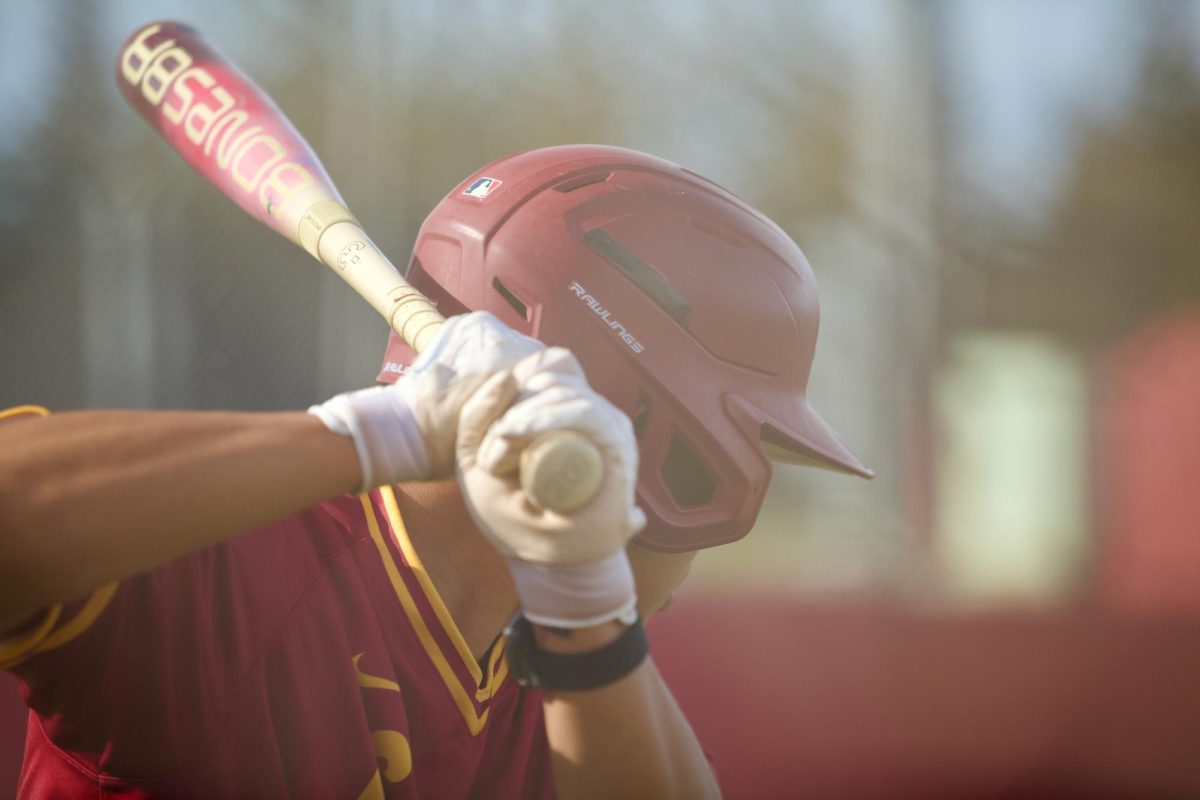 Catcher Owen Wang (De Anza No. 14) practices swinging in the on-deck circle at the De Anza College Baseball Field on Feb. 28.