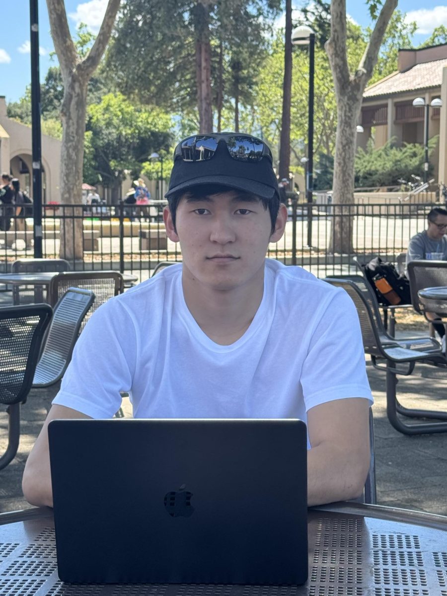 Nursen Ergeshov, 21, computer science major, studies outside the cafeteria on April 8.