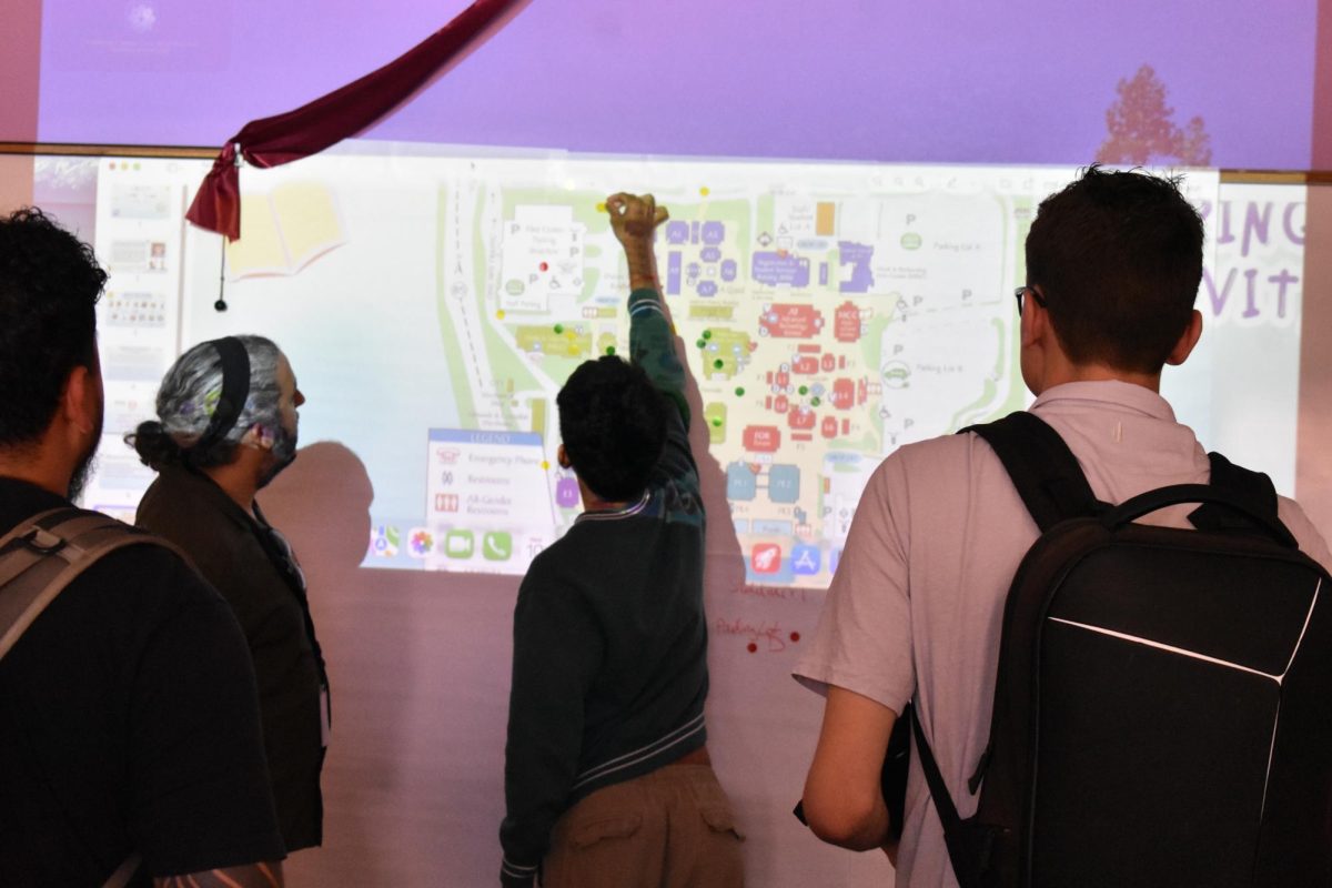 Students plot stickers on a campus map on areas they feel safe, with a consensus emerging around the Hinson Campus Center and library during Safety and Inclusion Summit in the Women's Resource and Advocacy Center on June 10.