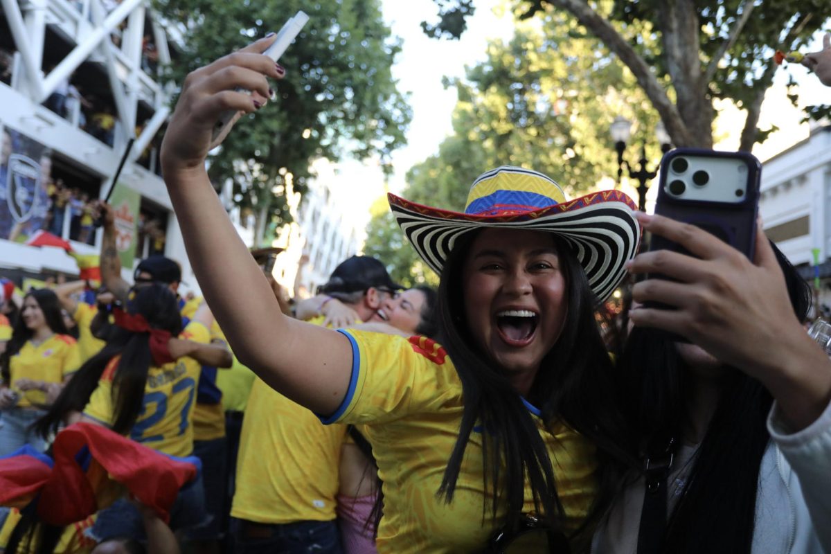 A Colombia fan celebrates the team's first goal against Uzbekistan in San Pedro Square on June 17.